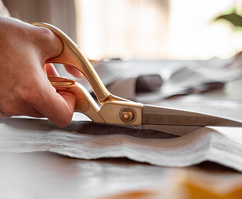 person-cutting-fabric-sewing